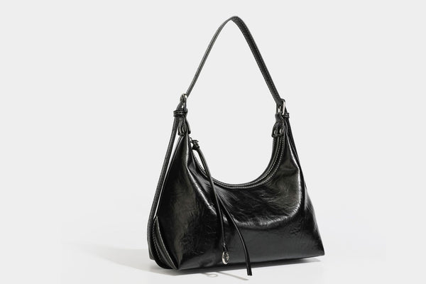 Slouchy hobo shoulder bag in glossy crinkled leather-look finish with zip-top closure and silver-tone ring hardware, detail