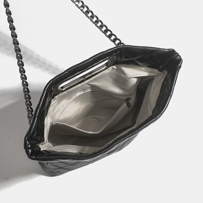Quilted diamond-stitch flap crossbody bag with gunmetal chain strap and cut-out bar handle, detail view 4