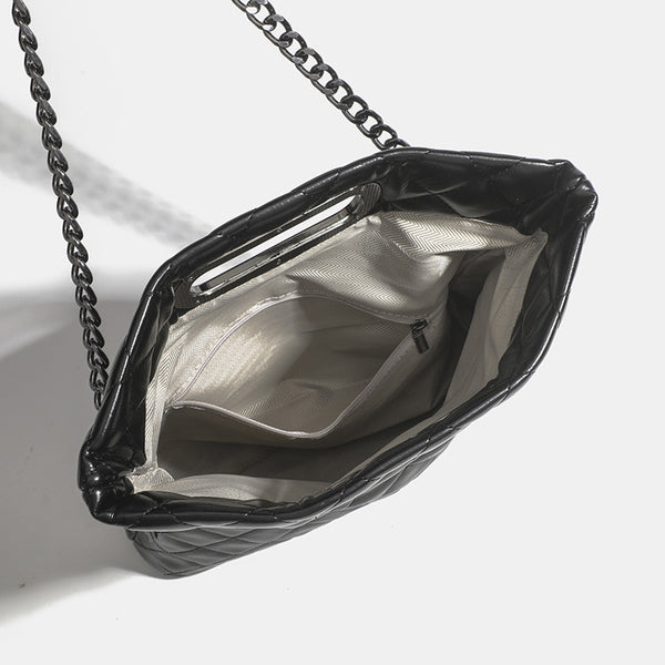 Quilted diamond-stitch flap crossbody bag with gunmetal chain strap and cut-out bar handle, detail view 4