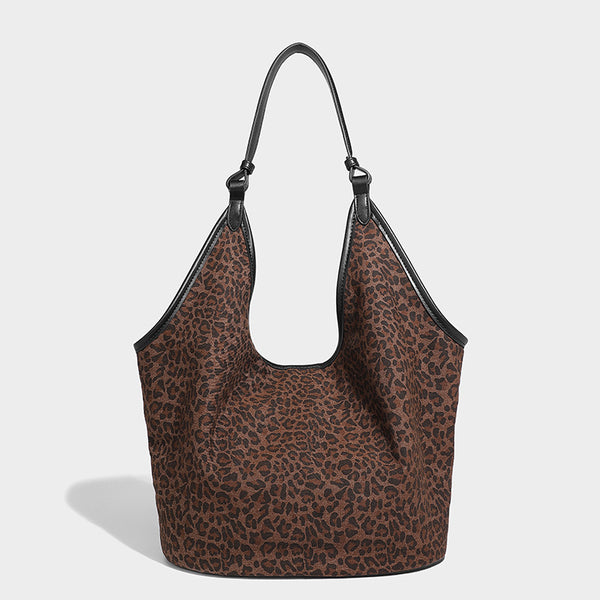Slouchy brown leopard jacquard hobo tote bag with black leather-look trim and single shoulder strap, shown with black, detail