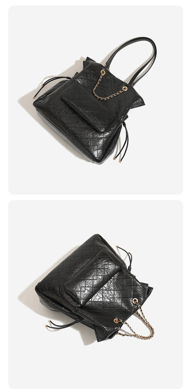 Large quilted leather-look drawstring backpack handbag with gold-tone chain handles and front flap pocket, detail view 9