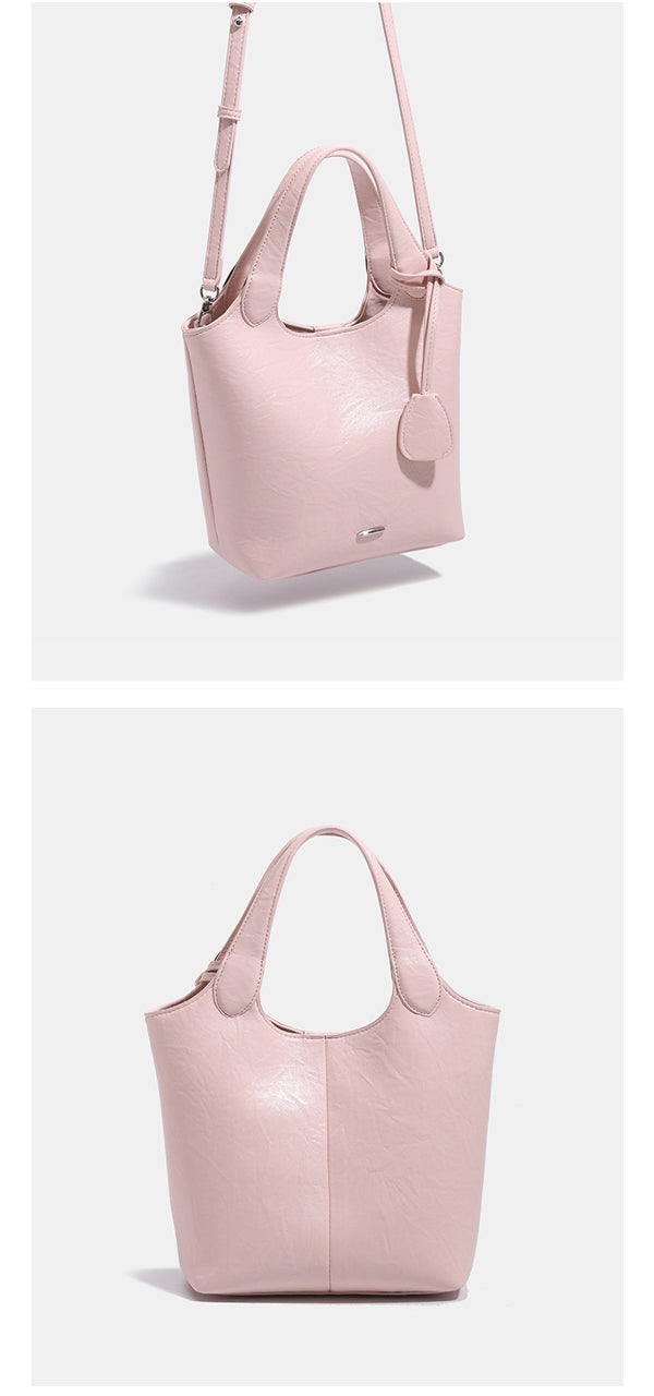 Soft glossy leather-look bucket tote bag with twin handles and detachable crossbody strap, detail view 12