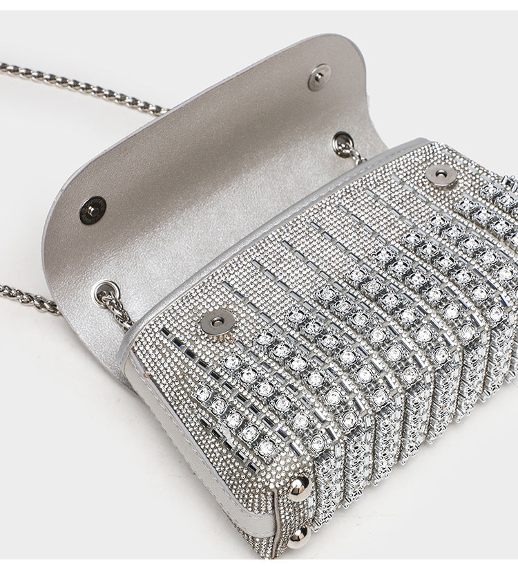 Structured mini flap crossbody bag covered in grid-set rhinestones with silver-tone chain strap, detail view 11