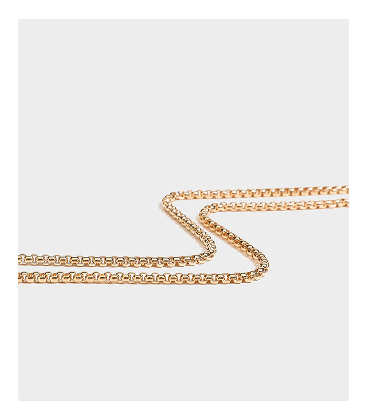 rectangular hard-case rhinestone evening clutch with sculptural gold-tone branch-and-bud top handle and detachable chain