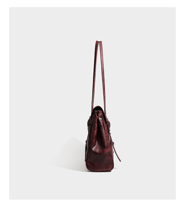 Structured flap-top shoulder tote bag in distressed leather-look finish with silver-tone buckle hardware and double shoulder