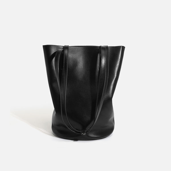 Large black smooth leather-look bucket tote bag with long shoulder straps and open top, detail view 6