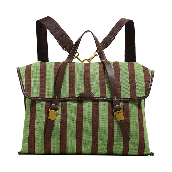 Structured striped canvas convertible satchel bag with leather-look trim, gold-tone buckle hardware, and backpack straps