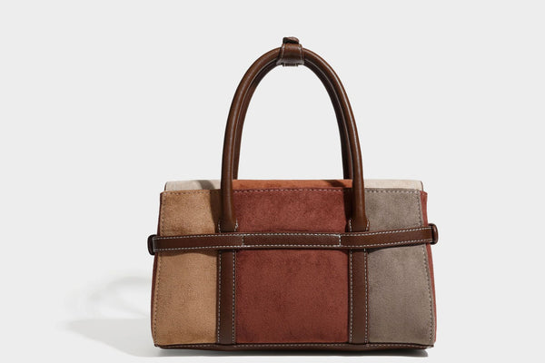 Structured color-block satchel bag in brown, rust, beige, and taupe suede-look panels with white topstitching, front buckle