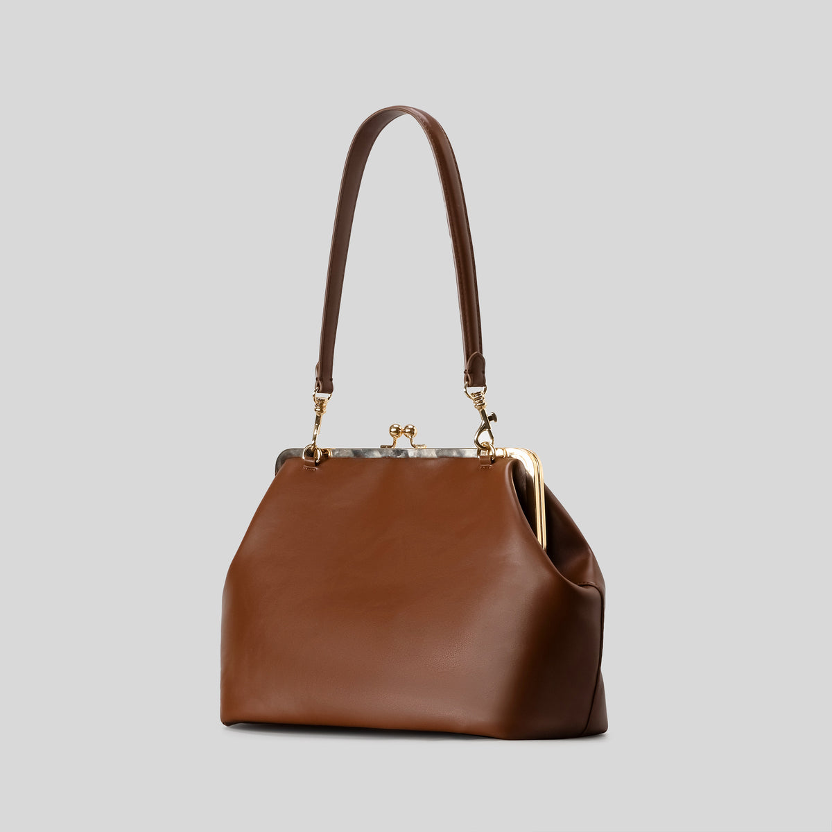 Oversized kiss-lock frame handbag with gold-tone metal clasp and smooth leather-look finish, front view