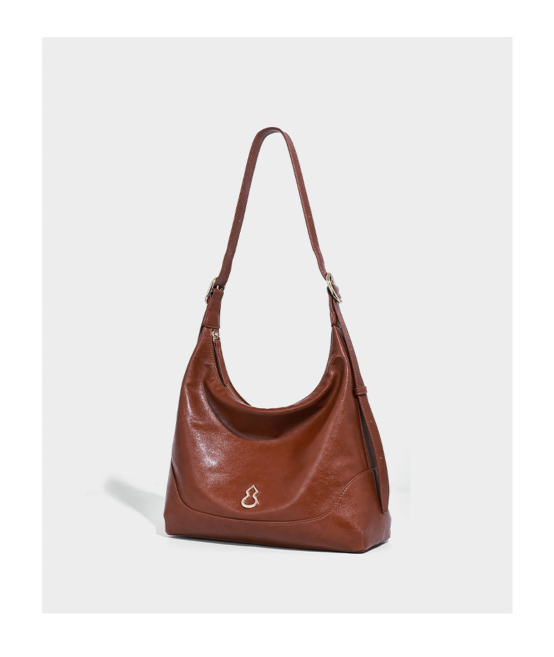 Glossy leather-look slouchy hobo shoulder bag with zip closure, gold-tone hardware, and adjustable strap, detail view 7