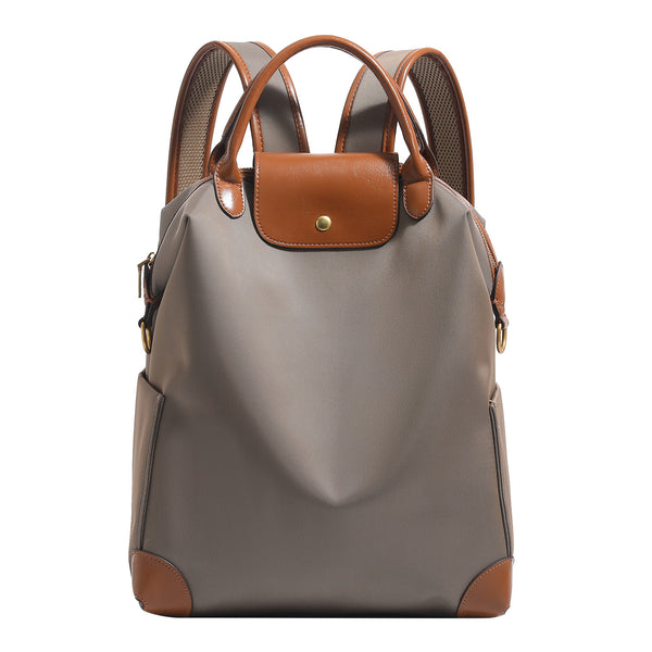 Large matte nylon backpack handbag with cognac leather-look trim, snap flap, and gold-tone hardware, detail view 5