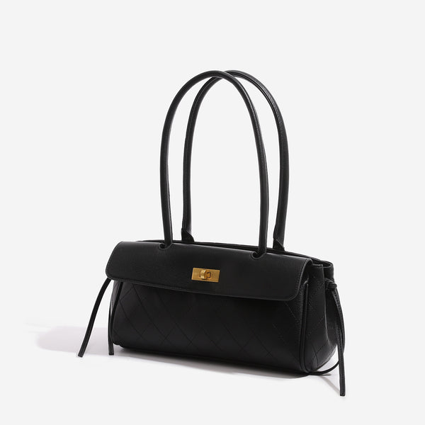Structured quilted diamond top-handle underarm shoulder bag with gold-tone turn-lock flap closure and side tie straps, detail