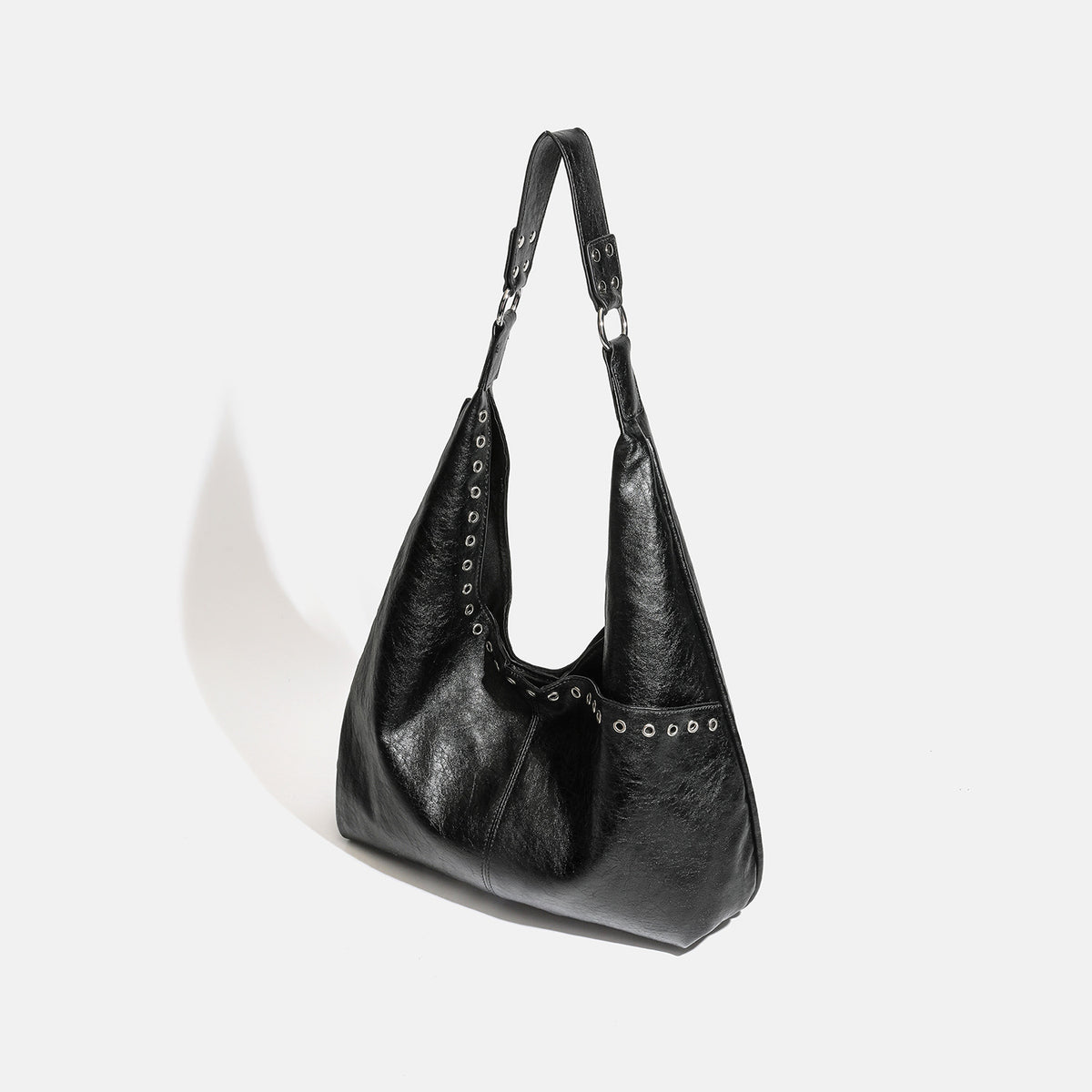 Large slouchy hobo shoulder bag with silver eyelet trim and glossy leather-look finish, detail view 3