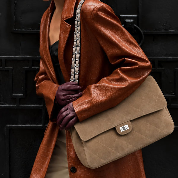 Quilted diamond-stitch flap shoulder bag with double silver chain strap and turn-lock closure in suede-look finish, detail