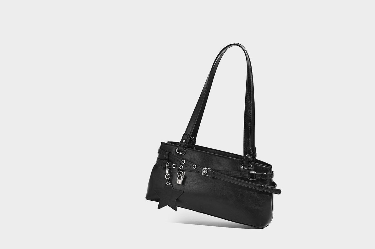 Structured glossy leather-look shoulder bag with wraparound belt straps, silver-tone hardware, and dangling star charm
