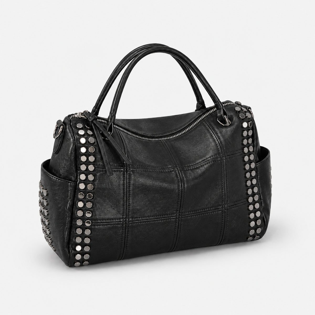 Black leather-look satchel bag with gunmetal rivet trim, grid-stitched paneling, dual rolled top handles, and curved zip