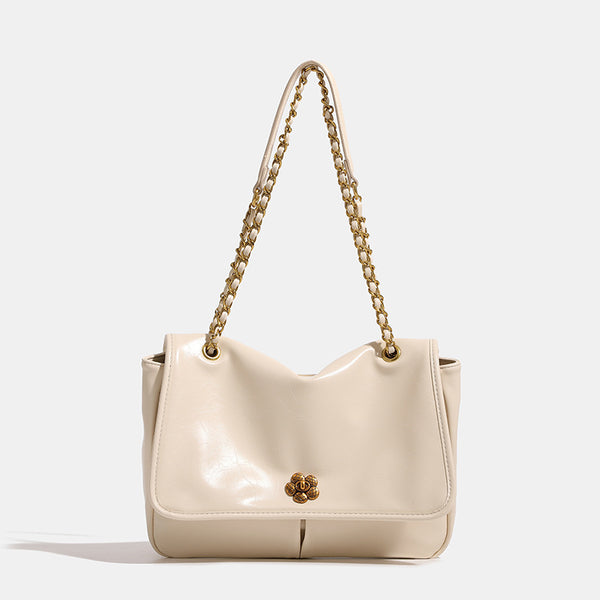 Structured flap shoulder bag with antique gold-tone chain strap and flower turn-lock clasp in crinkled leather-look finish