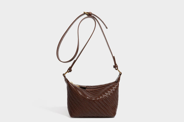 Small glossy basket-weave hobo shoulder bag in brown with knotted top handle, flap accent pocket, and gold-tone hardware