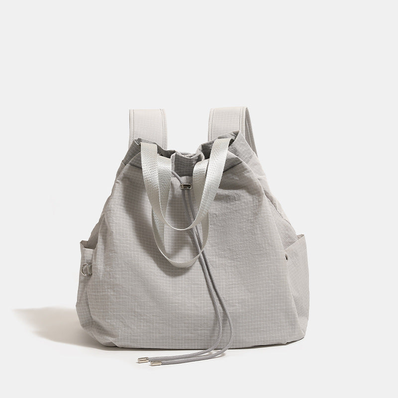 Large glacier gray grid-texture nylon drawstring backpack tote with dual top handles and adjustable backpack straps, detail