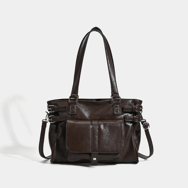 Large glossy leather-look tote bag with front flap pocket, silver-tone buckle hardware, dual top handles and detachable