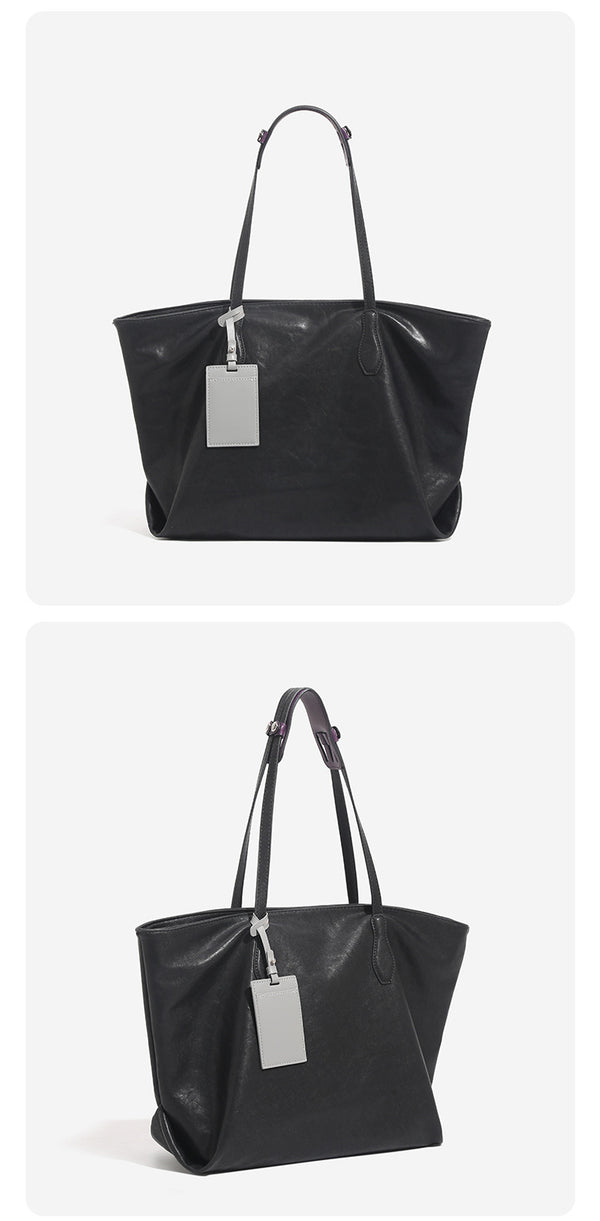 Large leather-look tote bag with trapezoid silhouette, double shoulder straps, and detachable hanging tag, detail view 11
