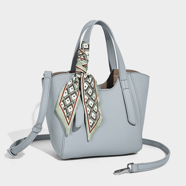 Structured pebbled leather-look tote bag with detachable scarf tie, dual top handles, and adjustable crossbody strap, detail