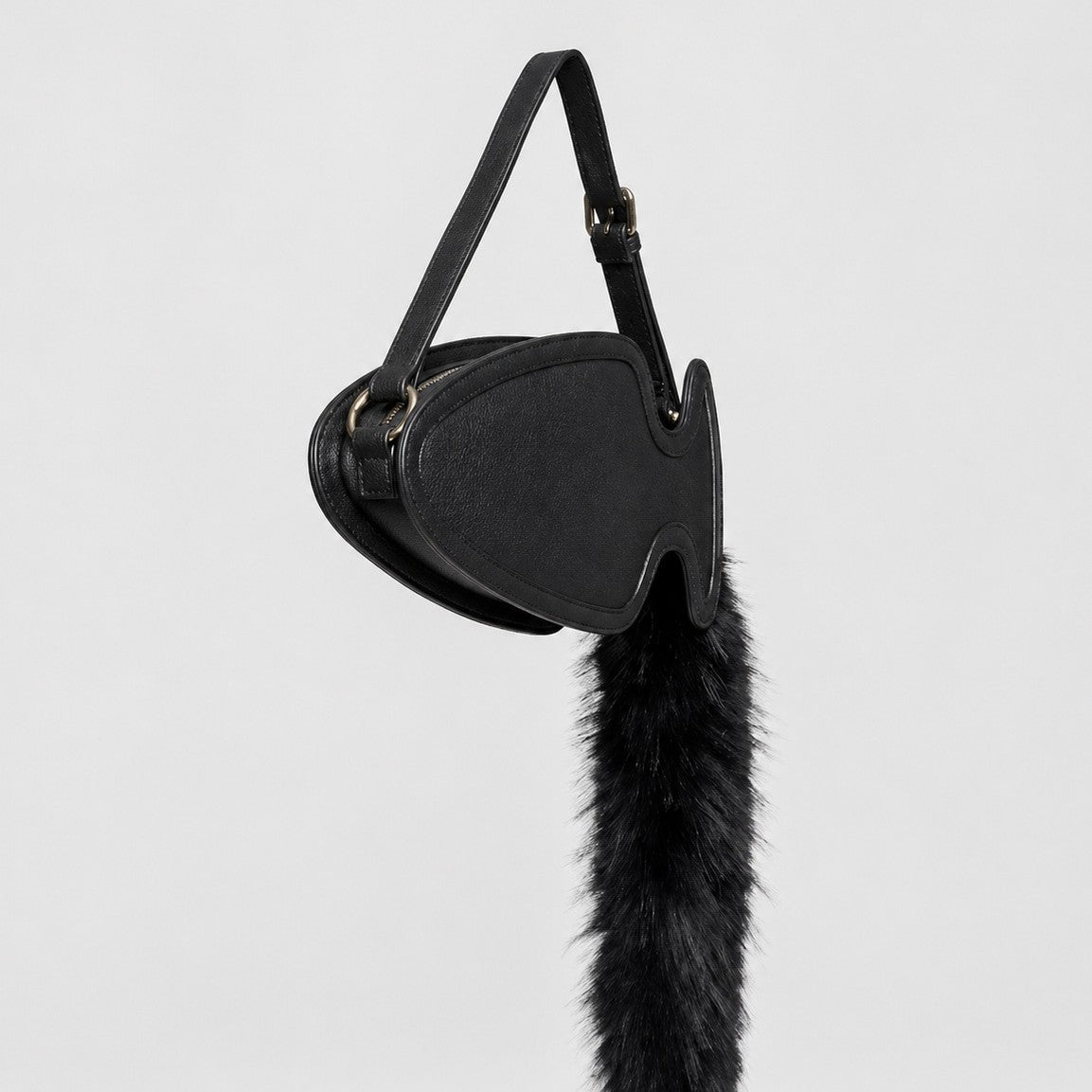 Fish-shaped pebbled leather-look crossbody bag with black faux-fur tail accent and adjustable shoulder strap, detail view 4