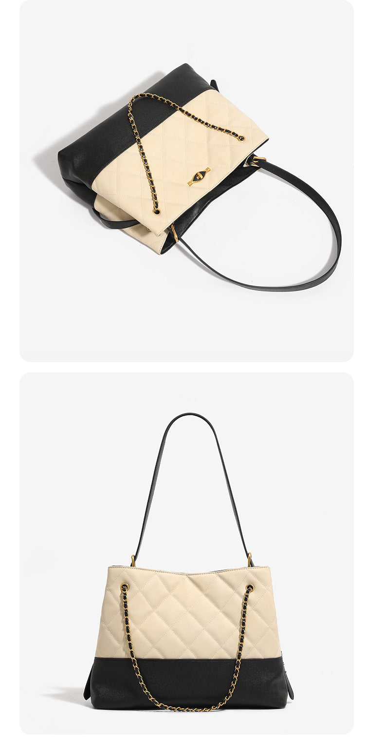 Large quilted two-tone shoulder tote bag with gold-tone chain handles and eye-shaped clasp hardware, detail view 11