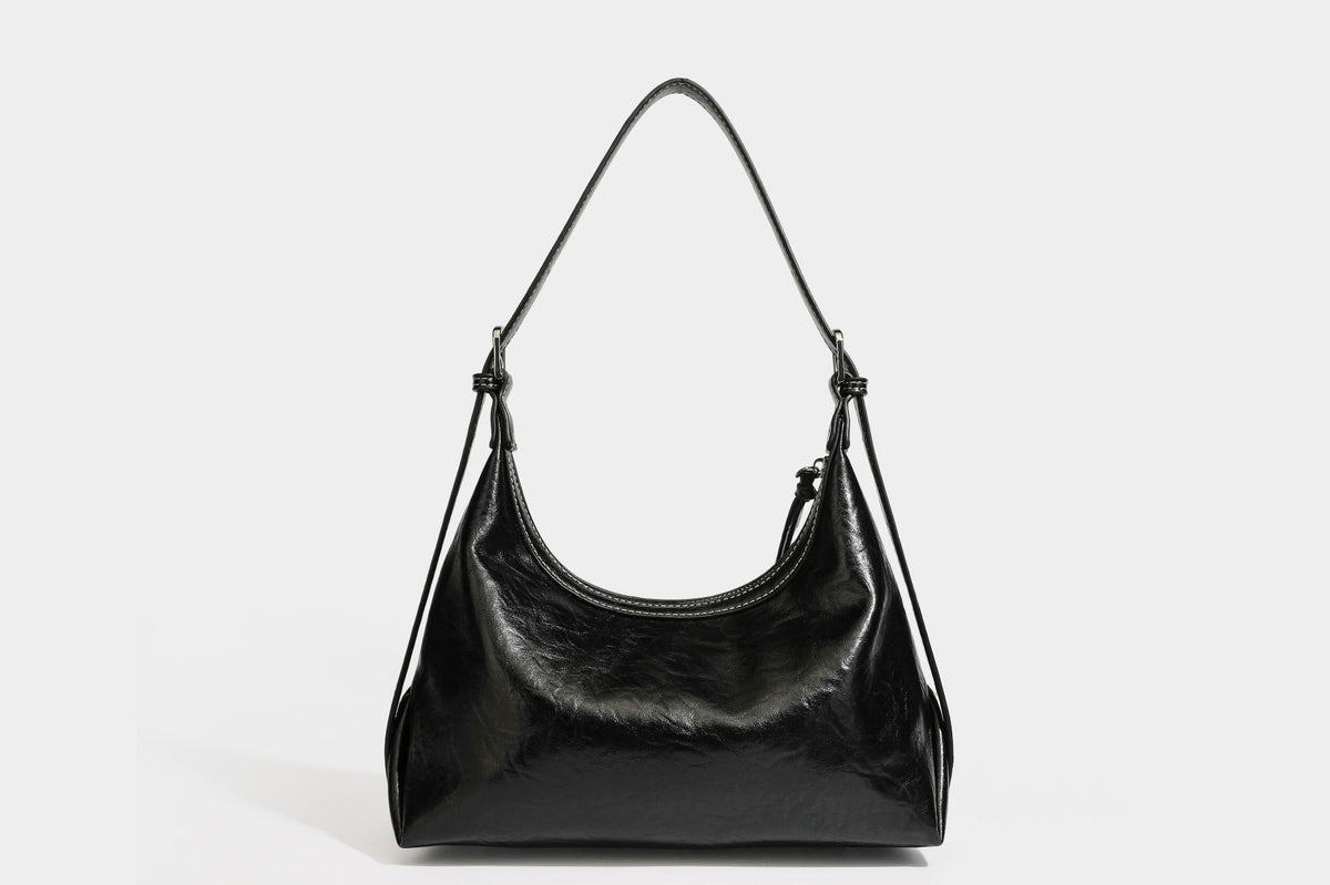 Slouchy hobo shoulder bag in glossy crinkled leather-look finish with zip-top closure and silver-tone ring hardware, detail