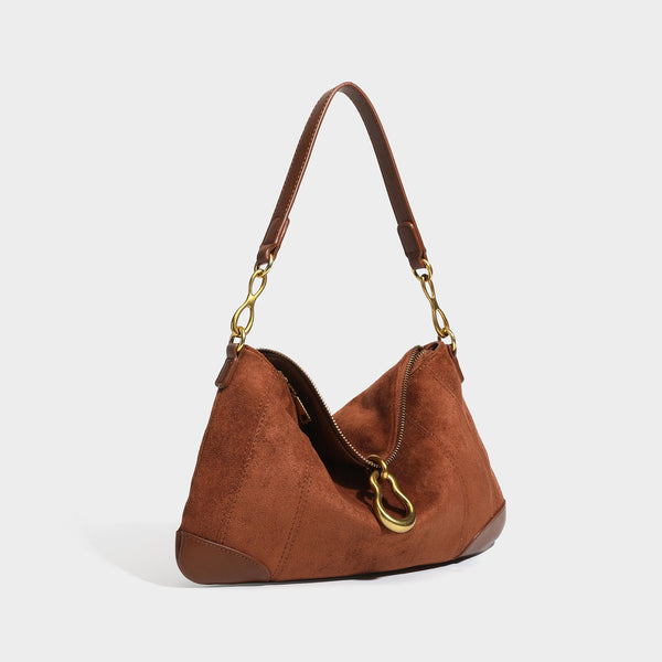 Slouchy denim shoulder bag with dark leather-look trim, gold-tone chain-link hardware, and top zipper closure, detail view 3