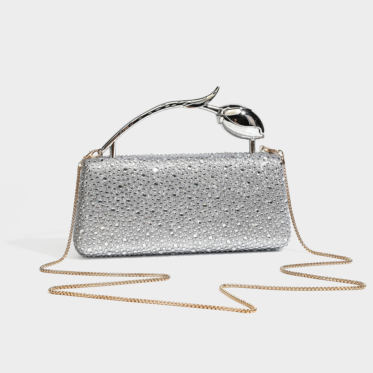 rectangular hard-case rhinestone evening clutch with sculptural gold-tone branch-and-bud top handle and detachable chain