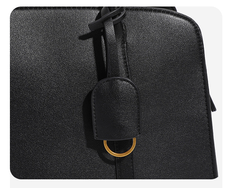 Structured retro Boston satchel bag with dual top handles, gold-tone ring hardware, and top zip closure, detail view 8