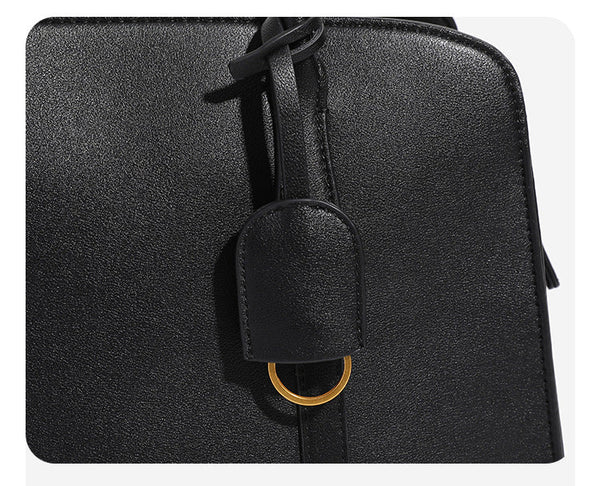Structured retro Boston satchel bag with dual top handles, gold-tone ring hardware, and top zip closure, detail view 8