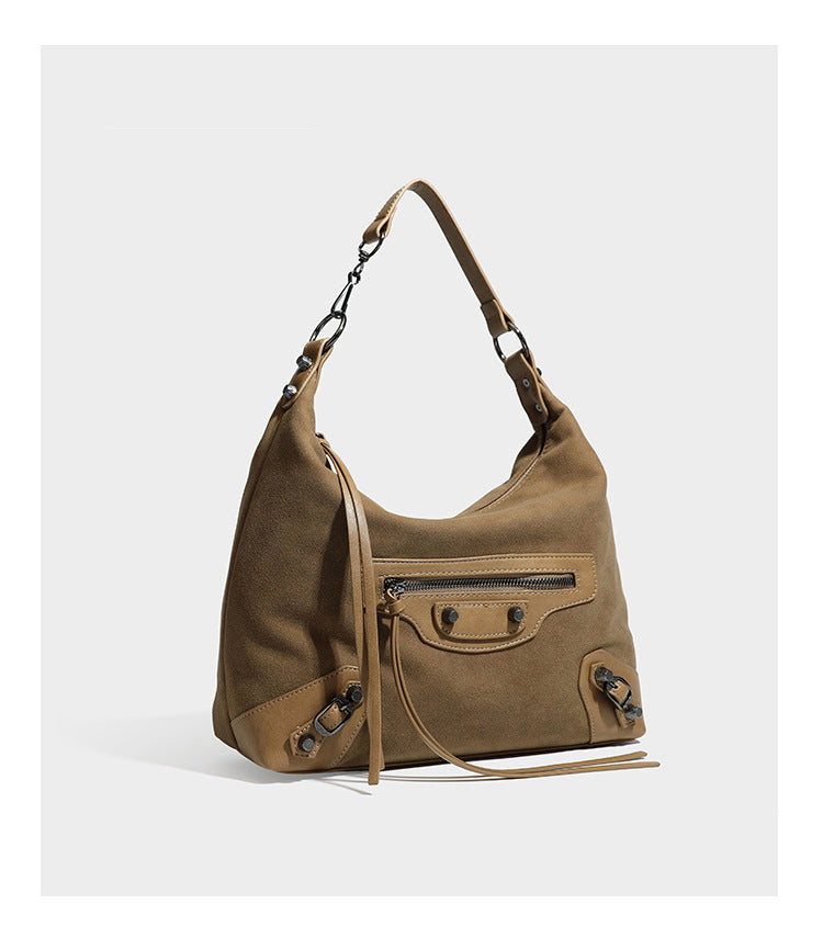 Slouchy suede-finish hobo shoulder bag with dark hardware, exterior zip pocket, tassel ties, and detachable crossbody strap