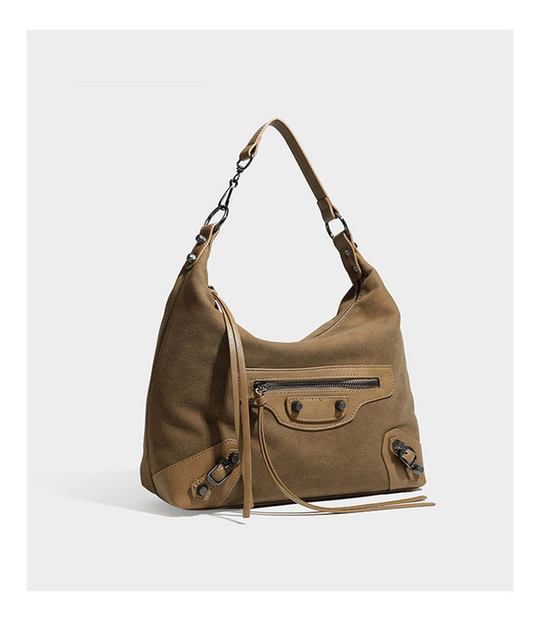 Slouchy suede-finish hobo shoulder bag with dark hardware, exterior zip pocket, tassel ties, and detachable crossbody strap