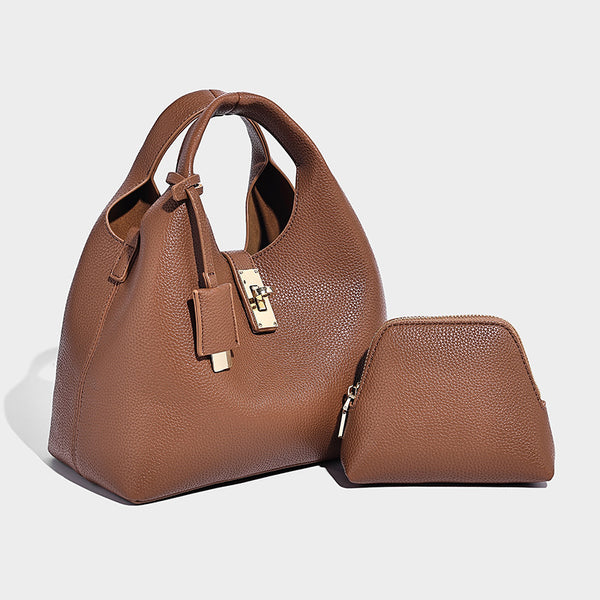 Structured pebbled-texture bucket bag with arched top handles, gold-tone turn-lock closure, and detachable shoulder strap