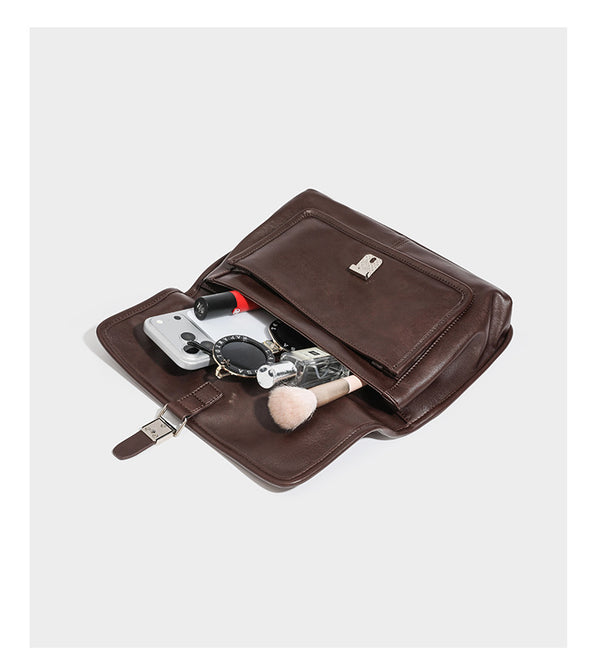 Structured rectangular flap satchel in espresso brown leather-look finish with silver-tone turn-lock buckle, top handle, and