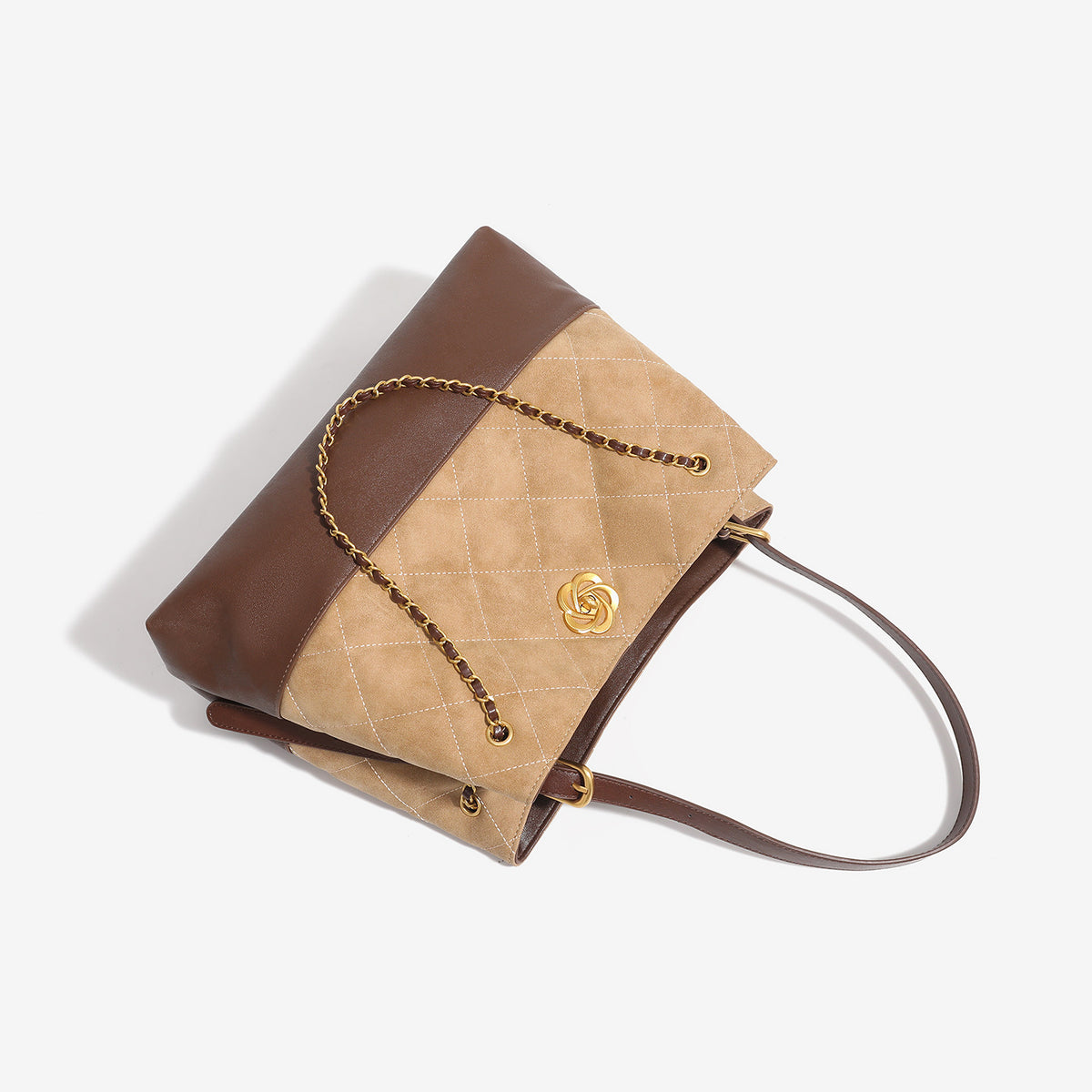 Two-tone tan quilted and dark brown leather-look tote bag with gold chain strap and floral knot emblem, detail view 4