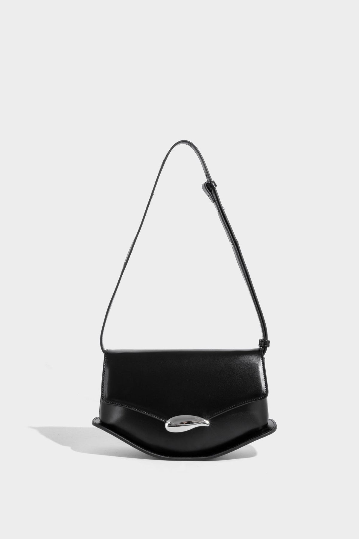Small structured saddle bag with glossy leather-look finish, angular flap front, silver-tone metal clasp, and slim