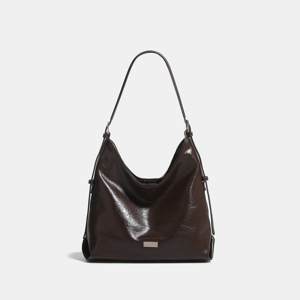 Slouchy hobo shoulder bag with glossy wrinkled leather-look finish, adjustable strap, and snap closure, detail view 9