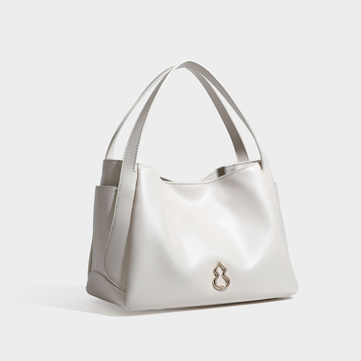 Structured glossy leather-look tote shoulder bag with dual top handles, detachable crossbody strap, side pockets, and, detail