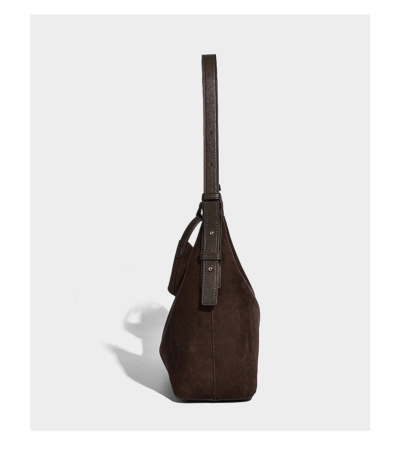 Dark brown suede-look hobo shoulder bag with top zip closure, adjustable strap, and small detachable mini pouch, detail view