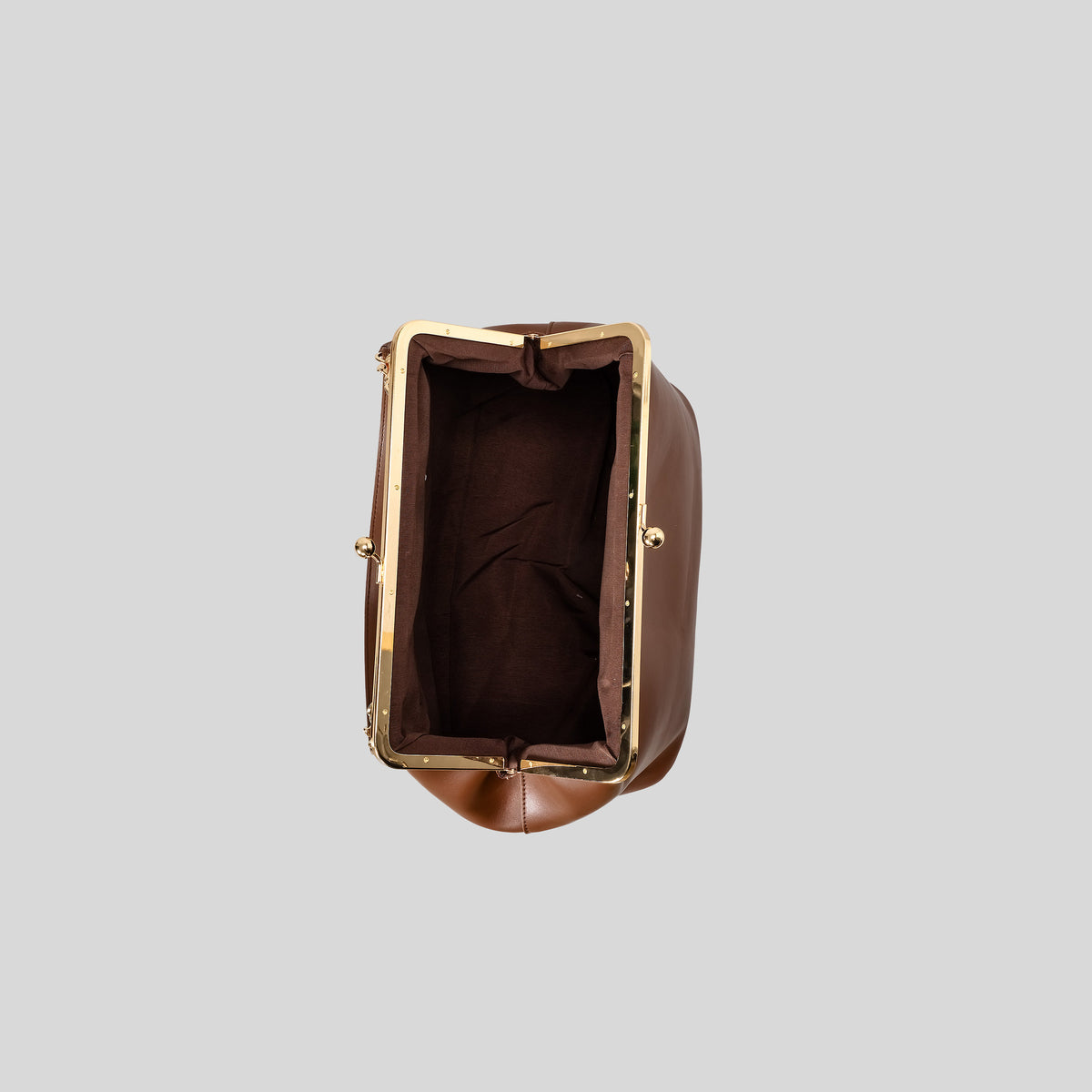 Oversized kiss-lock frame handbag with gold-tone metal clasp and smooth leather-look finish, detail view 4