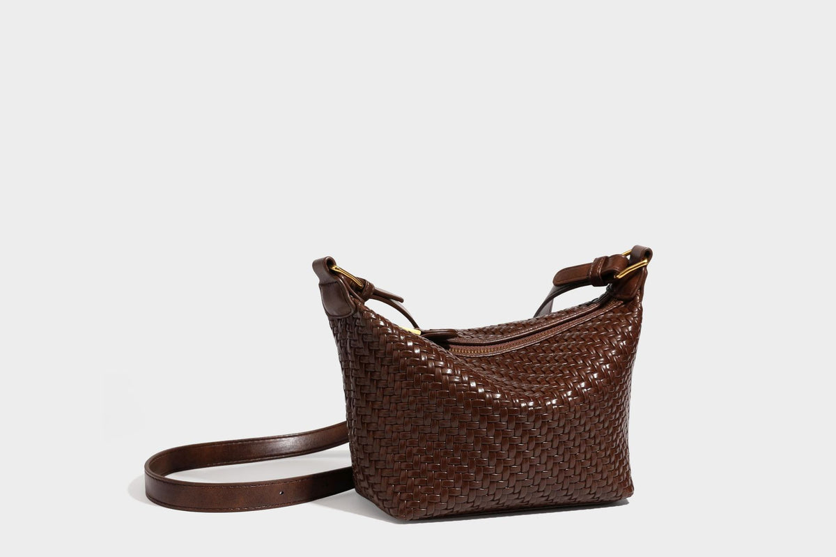 Small glossy basket-weave hobo shoulder bag in brown with knotted top handle, flap accent pocket, and gold-tone hardware