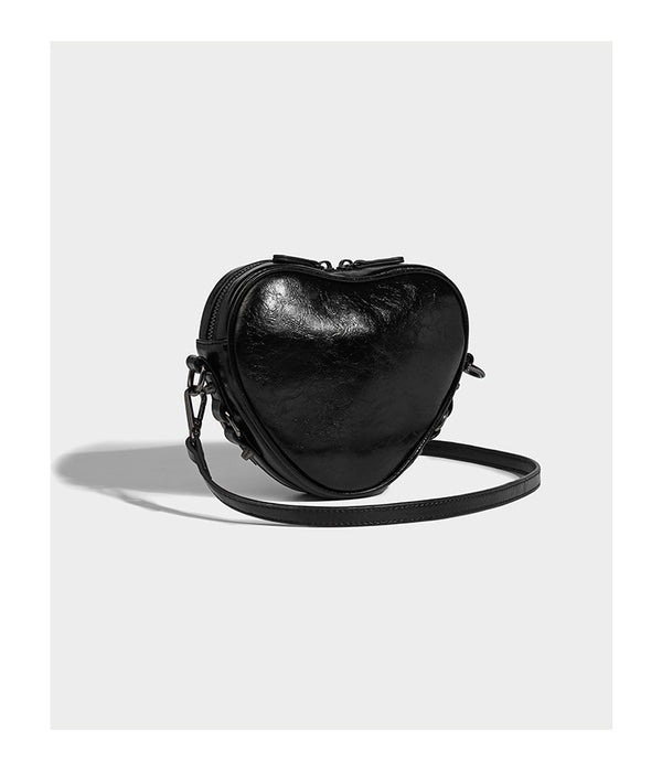 Mini heart-shaped crossbody bag with glossy crinkled finish and moto buckle hardware, detail view 11