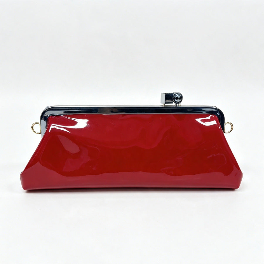 Strukturierte Clutch mit Kiss-Lock-Rahmenverschluss aus dunkelbrauner, krokodil-geprägter Lederoptik mit goldfarbenen Details und schmalem