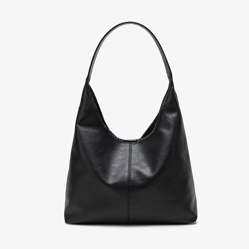 Large slouchy hobo shoulder bag in pebbled matte leather-look finish with single flat strap, detail view 6