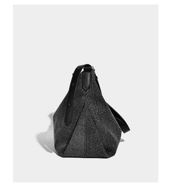 Charcoal denim-textured slouchy hobo bag with zip-top closure, silver-tone hardware, and adjustable leather-look crossbody