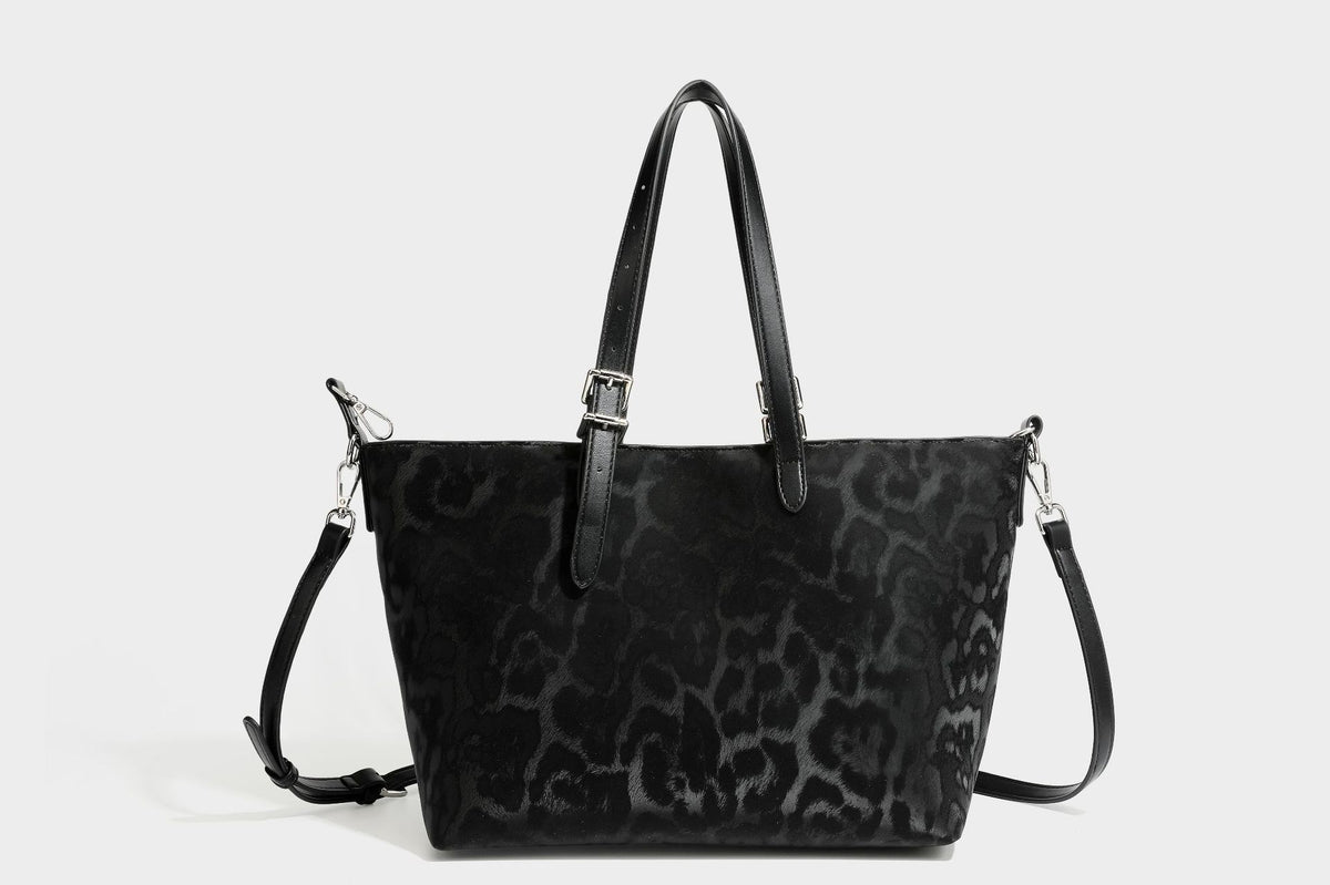Glossy leopard-print tote bag with leather-look dark trim, dual top handles, detachable shoulder strap, and attached front