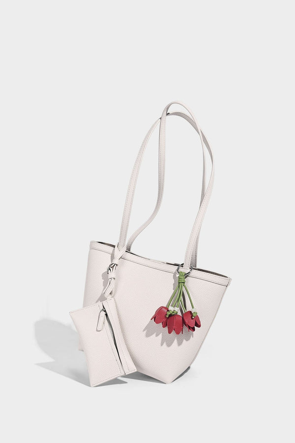 Structured pebbled leather-look tote bag in taupe with long shoulder strap, detachable zip pouch, and pink tulip flower